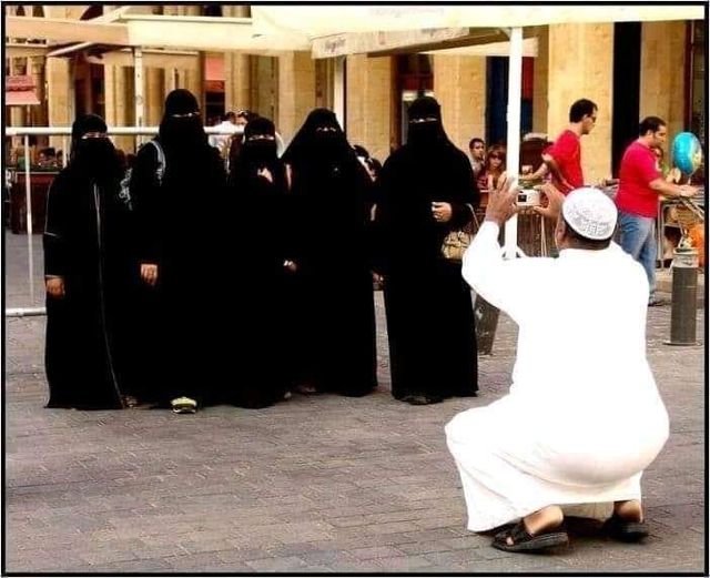 muslim taking a picture of his wives?  All covered head to toe in garments